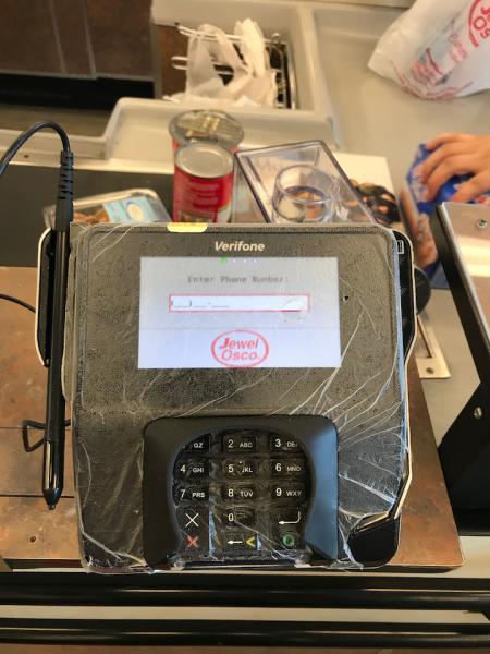 Plastic wrap covering a credit/banking card terminal at a checkout line at a grocery store in the Chicago suburbs. The wrap was added to machines at most stores in an effort to make decontamination of the machines easier. #COVID19