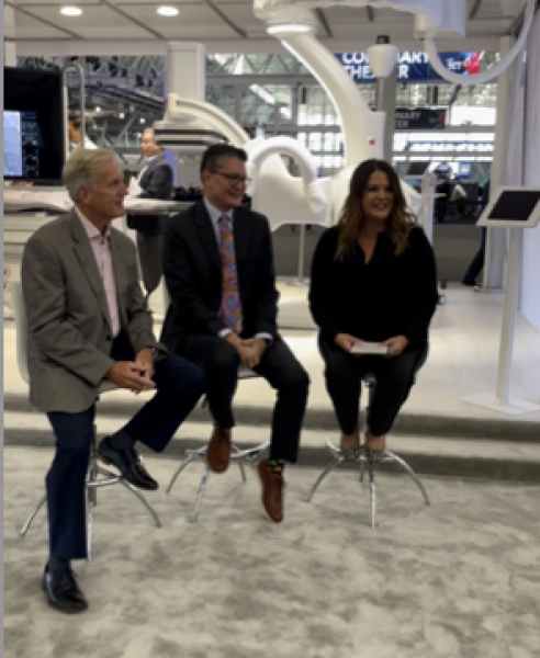Jenny Dunkley and Terry Crawford of GE film a Cardiology Coffee Break with Michael Lim, MD, FACC, FSCAI, Chief, Cardiac Catheterization Lab, Hackensack Meridian Medical Group, from the show floor during TCT2022. 