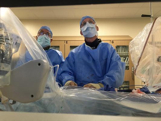 Interventional procedures have become increasing complex with a shift from open surgical procedures to transcatheter procedures. This is a chronic total occlusion (CTO) case at the University of Colorado to reopen a bypass graft. It shows doctors John Messenger and Kevin Rogers. Photo by Dave Fornell