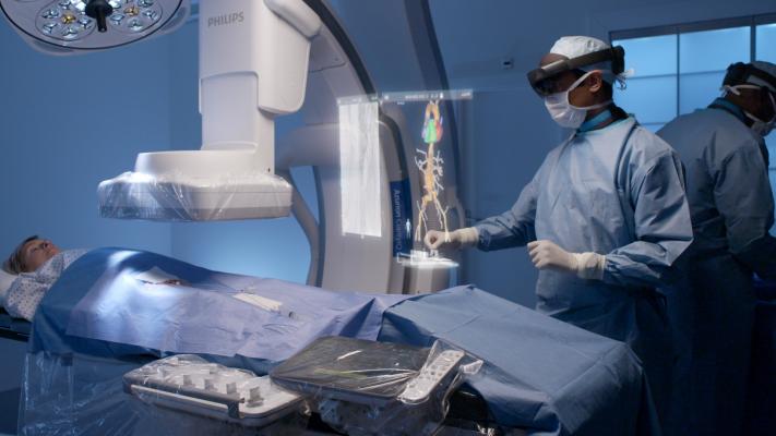 Philips and Microsoft have partnered to develop an augmented reality system to help imporve workflow and procedural navigation in the cath lab. Physicians wearing visors can view and interact with true 3-D holograms above the patient on the table and manipulate the image with voice and hand motion commands to avoid breaking the sterile field. 
