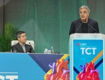 CRF President and CEO Juan F. Granada, MD, looks on as Jean Fajadet, MD, accepts the Master Operator Award during a Sept. 18 ceremony at TCT2022.