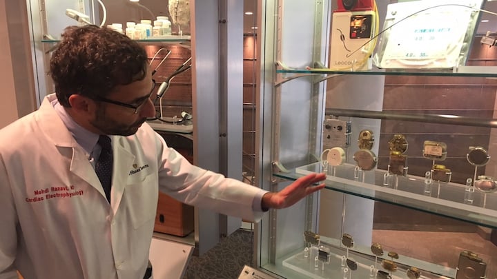 Mehdi Razavi, M.D., sharing the history of the pacemaker on display in the Texas Heart Institute Wallace Wilson Museum in Houston.