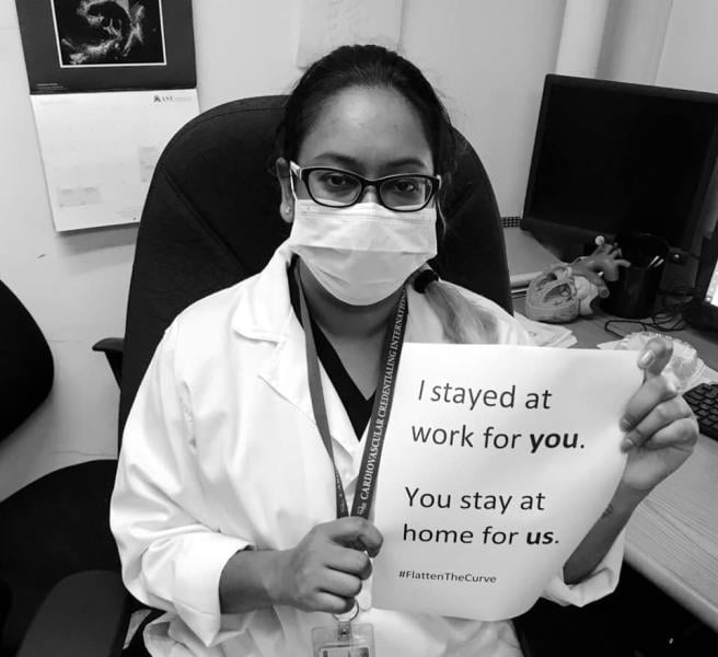 A viral trend among healthcare works across social media has been to post selfies with signs that say "We stayed at work for you, you stay home for us," to drive home the message that social distancing is needed for COVID-19 containment efforts. Pictured here is 12 Ramona Chanderballi, a radiology technologist in Lives in Georgetown, Guyana, South America.