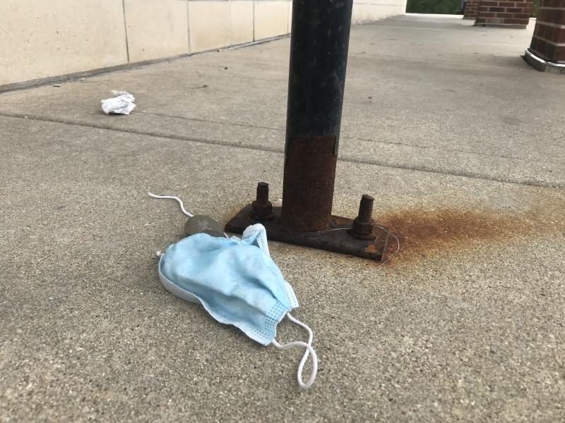 A discarded face mask in the parking lot of a CVS pharmacy in the Chicago suburbs. Facemasks a rubber gloves have become standard litter on the ground in urban areas during the COVID-19 era. Photo by Dave Fornell
