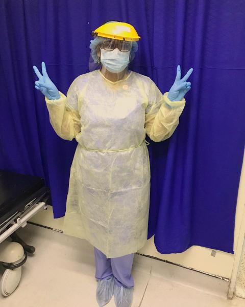 Sonographer Ramona Chanderballi donning pull PPE before performing an echocardiogram at her hospital in Georgetown, Guyana, in South America in August 2020.