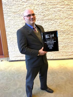 DAIC Editor Dave Fornell displays the 2018 Neal Award for Best Use of Social Media
