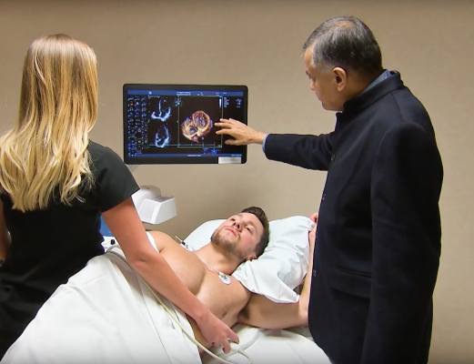 Dr. Bijoy Khandheria, a cardiologist from Aurora Health in Milwaukee, explains a cardiac echo image with a patient.