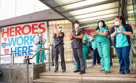 Signs for "Heroes work here" outside healthcare facilities and even the homes of clinicians have popped up across the country. This photo shows healthcare workers at the Lenox Health emergency room entrance being greeted to cheers and thanks for their essential service during the COVID-19 pandemic in New York City at a public thank you event May 21, 2020. #COVID19 #SARScov2 #pandemic #LenoxHill 