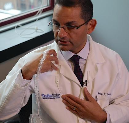 Navin Kapur, M.D., Tufts Medical Center, shows preCardia device and its anatomical positioning in the patient to treat heart failure..
