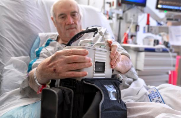 LVAD patient Richard Huggins with the external control and power unit for his new EvaHeart2 left ventricular assist device at Penn State Health's Hershey Medical Center. 
