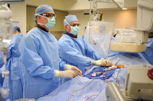 Henry Ford Hospital cardiologists Adam Greenbaum and William O'Neill performing a TAVR procedure. The firsttranscaval valve replacement, Henry Ford Hospital, Detroit Michigan, success rate, JACC study, TCT 2016