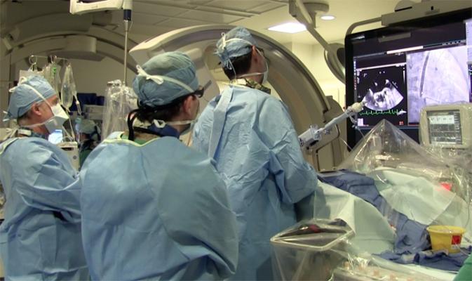 The implantation of a MitraClip takes a heart team. Three cardiologists are seen here and off frame is an anesthesiologist, echocardiographer and the cath lab support staff. Photo from a MitraClip procedure at the University of Colorado Hospital with doctors Dominick Wiktor and John Carroll. 