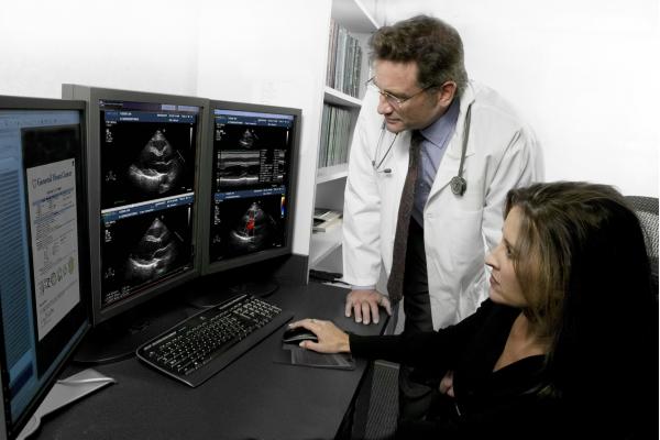 The Novarad CardioReport echo reporting system. The right screen shows the cardiac ultrasound images and the report on the left screen.