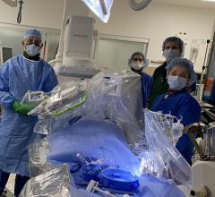 Christopher Baker, M.D., and his team perpare to perform their first robotically navigated carotid artery stenting procedure at Hoag Memorial Hospital Presbyterian. The Corindus Corpath robotic system can be seen over the patient on the table.