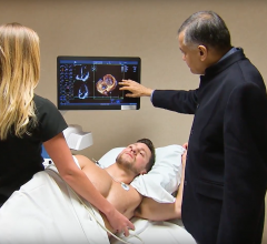 Dr. Bijoy Khandheria, a cardiologist from Aurora Health in Milwaukee, explains a cardiac echo image with a patient.