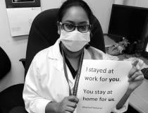 A viral trend among healthcare works across social media has been to post selfies with signs that say "We stayed at work for you, you stay home for us," to drive home the message that social distancing is needed for COVID-19 containment efforts. Pictured here is 12 Ramona Chanderballi, a radiology technologist in Lives in Georgetown, Guyana, South America.
