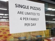 A sign noting the limit of frozen pizzas customers can buy at a grocery store in Aurora, Illinois. Photo by David Lasee.