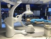 GE Healthcare showed its new Allia IGS7 angiography system. It was released in 2020 and the first system is now being installed. It features an all new user interface with a set of controls duplicated on three sides of the detector head. A set of controls for the system are also available on a small cart, a taking up the same amount of floor space as an IV stand so the C-arm can be operated from anywhere in the lab. Read more