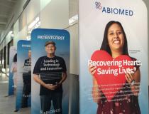 There are several reminders around the Abiomed headquarters office that the products employees there make are designed to help save lives. These are among many posters of actual patients who received Impella devices, which helped their survival.