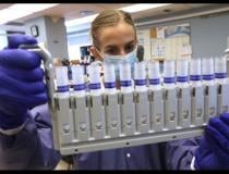 Jennifer Lindsley loads several tubes of patient samples to test for COVID-19 at a hospital lab at Rush University Medical Center in Chicago on Oct. 20, 2020. <a href="https://www.newswise.com/coronavirus/rush-university-medical-center-surpasses-100-000-covid-19-tests/?article_id=741929"> Read the article.</a>  Photo Courtesy of Antonio Perez / Chicago Tribune. 