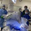 Christopher Baker, M.D., and his team perpare to perform their first robotically navigated carotid artery stenting procedure at Hoag Memorial Hospital Presbyterian. The Corindus Corpath robotic system can be seen over the patient on the table.
