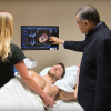 Dr. Bijoy Khandheria, a cardiologist from Aurora Health in Milwaukee, explains a cardiac echo image with a patient.